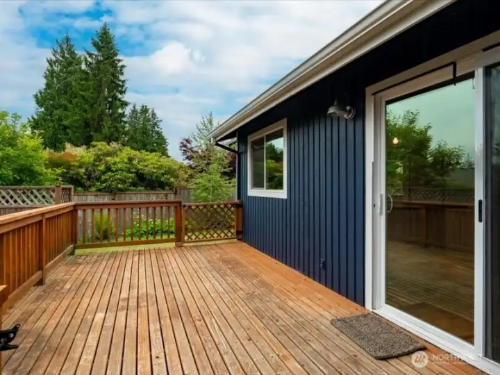 Looking across the large back deck that opens to the dining room. Looking across the large back deck that opens to the dining room.