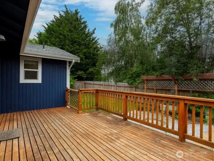 Looking at the back deck where there is a lawn beyond the gravel fire pit area. Looking at the back deck where there is a lawn beyond the gravel fire pit area.