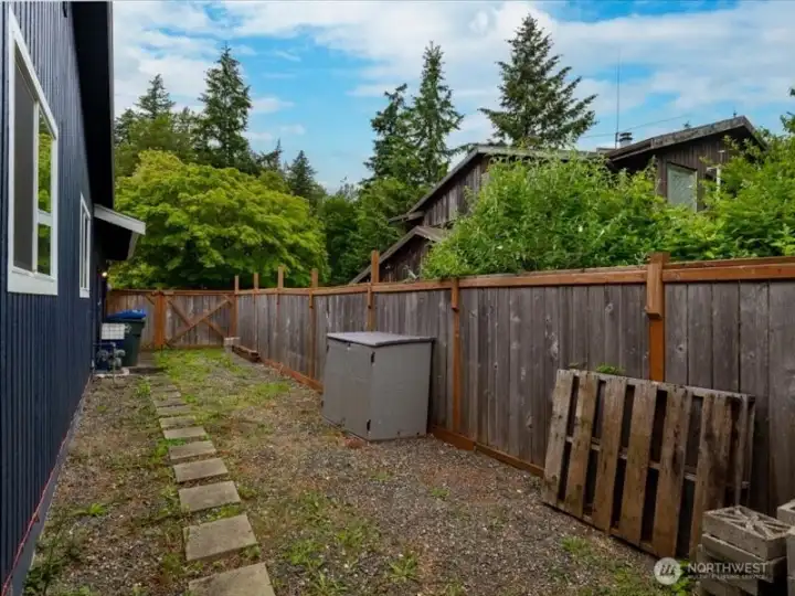 The side yard is all fenced and has a large gate. There is a door that opens into the garage as well. The side yard is all fenced and has a large gate. There is a door that opens into the garage as well.
