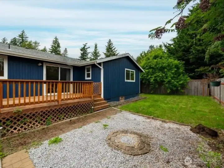 Looking at the great crushed gravel fire pit area and the rear elevation of the home. Looking at the great crushed gravel fire pit area and the rear elevation of the home.
