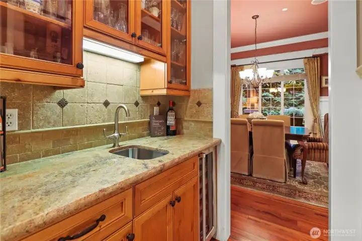 Butler's pantry between the kitchen and dining room with sink and wine fridge.