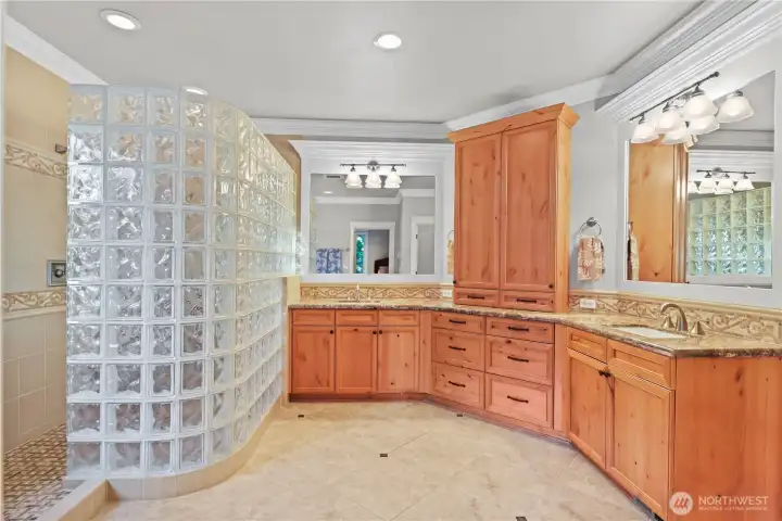 Primary bath with double shower, jetted tub, spacious double vanity, large walk-in closet and separate toilet room.