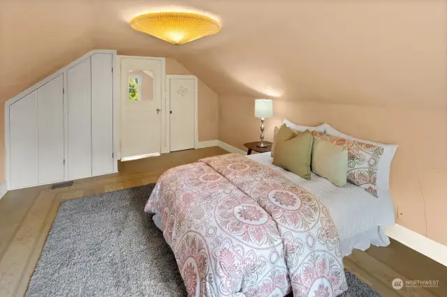 Another angle of the larger upstairs bedroom, showing two closets on each side of the entrance door.