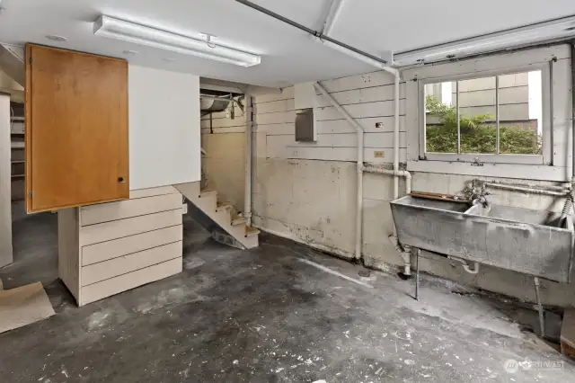 Another view of the utility room in the basement - high ceilings and plenty of storage space, including a closet under the stairs.