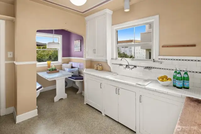 Vintage kitchen tile and cabinets, plus eating nook with built-ins.