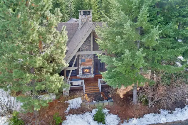 Enjoy the outside covered deck with stone fireplace and mountian views in the distance.