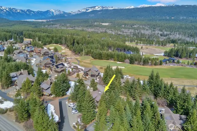 Home nestled in the pines with garage for 2 cars off to left of photo.