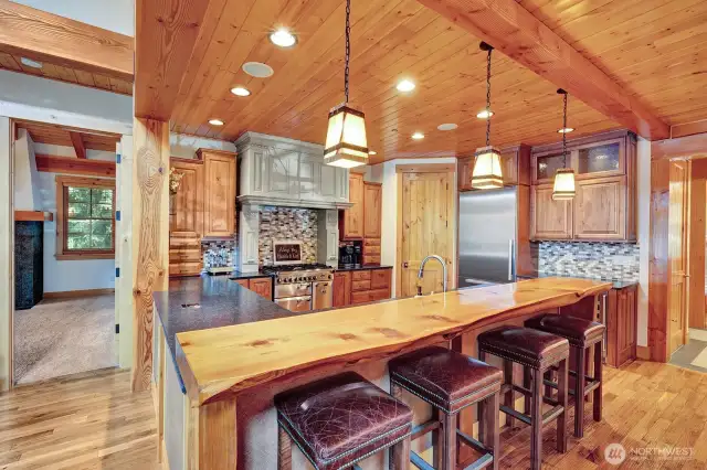 Bar off kitchen surrounded by warm wood accents.