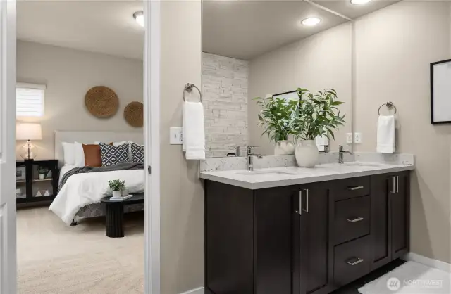 Primary bedroom with walk in bathroom that has a double vanity