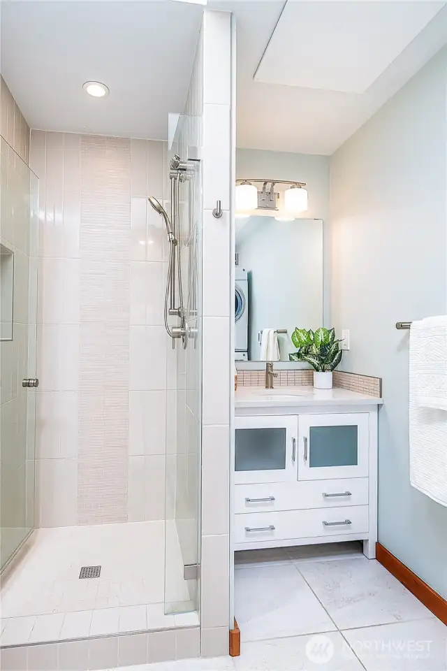 Main bath with tiled shower.
