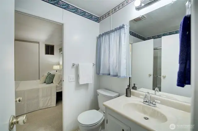 Main bath accessed from bedroom & utility room