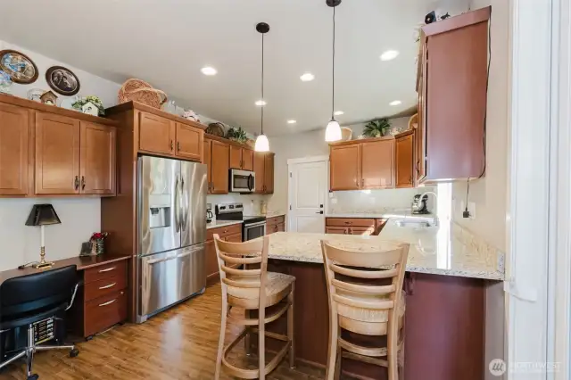 Eating bar in kitchen with also  showing desk/office area
