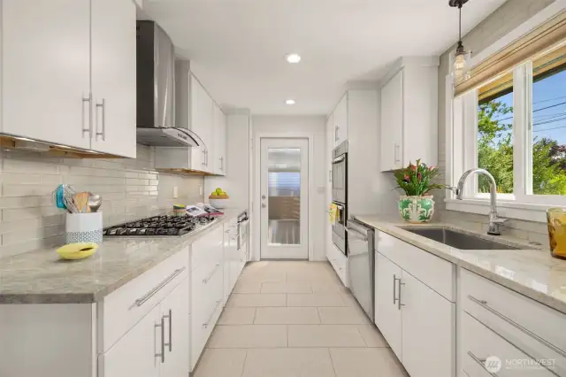 Updated kitchen with natural stone countertops.