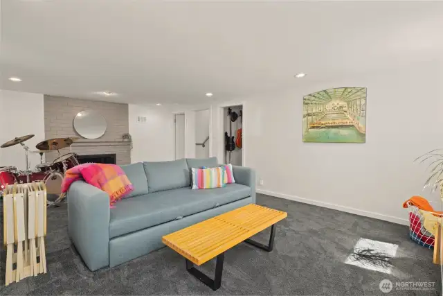 The lower level rec room of the main house features a wood burning fireplace.