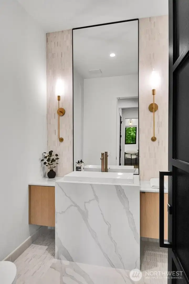 Main level powder room with waterfall quartz countertop