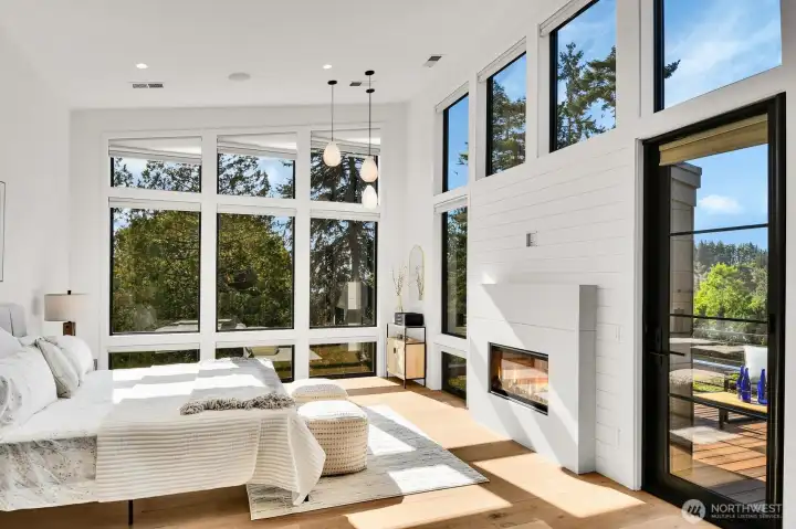 Primary bedroom with gas fireplace and private deck