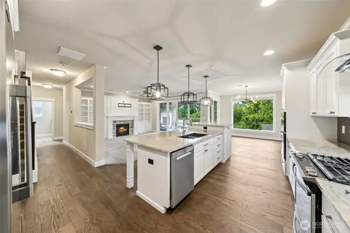 Beautifully updated kitchen with freshly painted cabinets, island, and living room built-ins.