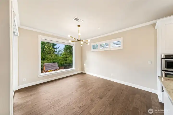 Dining area off the kitchen with large window looking out to the backyard.