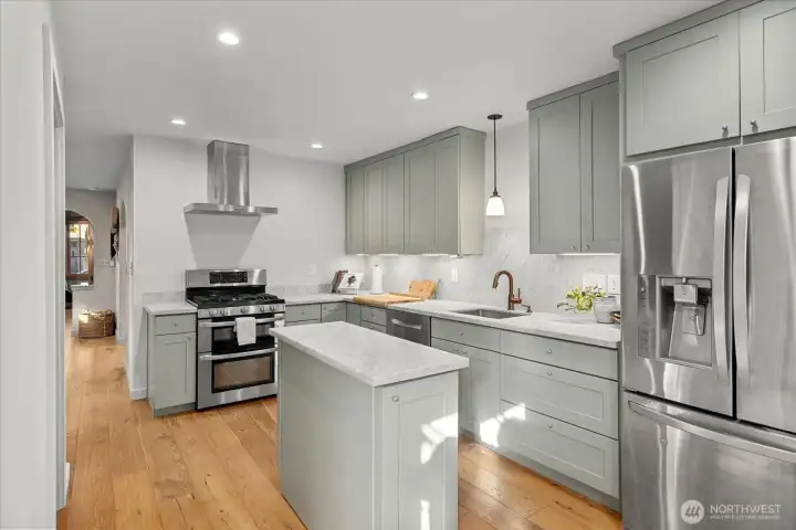 French-inspired kitchen pairs honed Carrara marble counters with 'Farrow & Ball' cabinetry, Brizo hardware, and stainless Bosch + LG appliances — a space that’s as beautiful as it is functional.