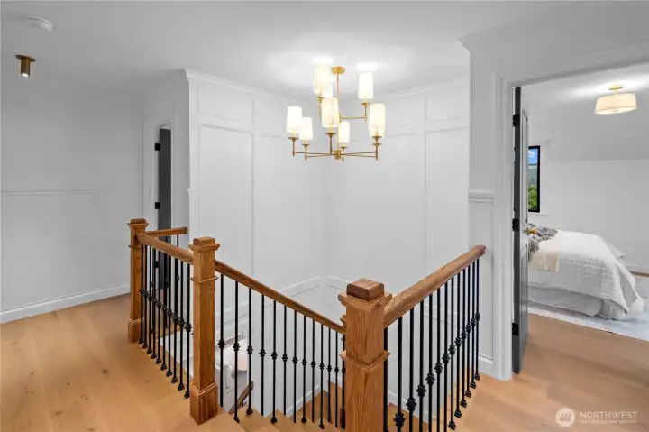 Custom stairway and fixture leading to 3 upstairs bedrooms including the Primary en suite and attic retreat!