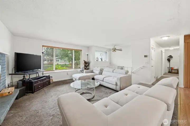 Side angle of the living room with view of the hallway that leads to bedrooms and bathrooms!