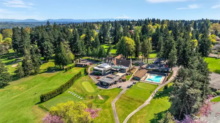 Drone shot looking down on the golf course clubhouse, pool, driving range, etc.
