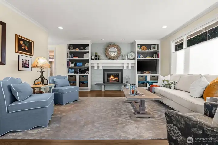 The living room is cozy with the fireplace, new crown molding, engineered hardwoods and warm light flowing in through the windows. Have a conversation with friends or curl up with a book.
