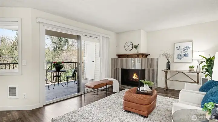 Living room has wood-burning fireplace with upscale tile surround.