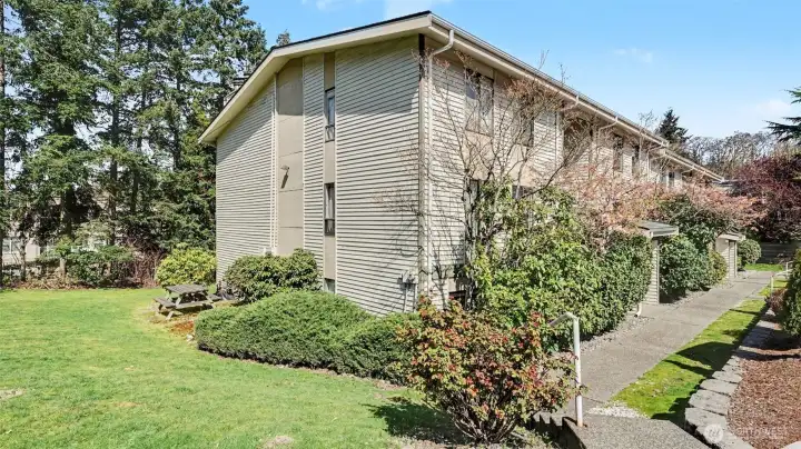 Lawn with picnic table.
