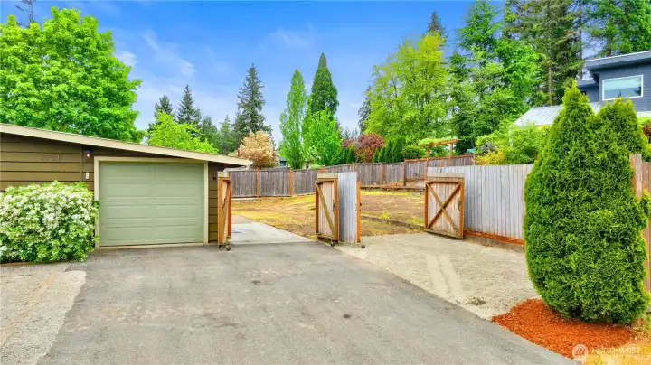 The property features a one-car garage and two fenced gate entrances with enough space to park two RVs.