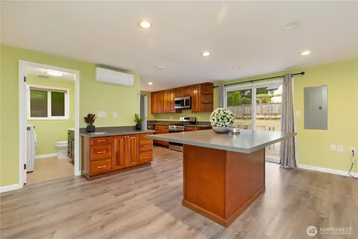 A spacious island is positioned in front of the kitchen.