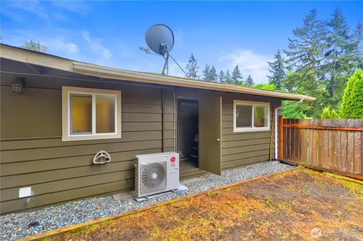 An air conditioning unit located next to the detached storage space.