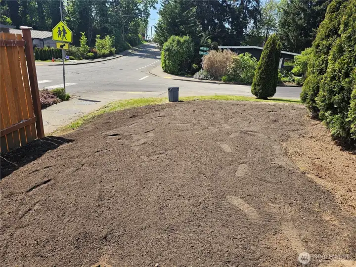 The front yard is currently being freshly landscaped with new lawn installation.