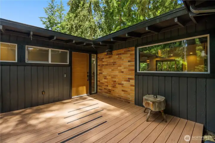 Set back from the street, this semi-enclosed and oversized wooden Front Deck, is private and great for relaxing outdoors!