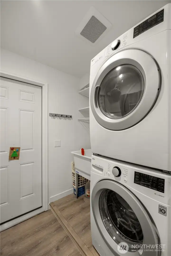 Utility Room includes front-loading Washer/Dryer, sink, and storage shelves!