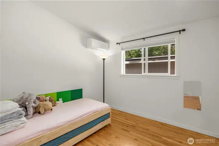 BR#3: Well-sized, bright third bedroom with hardwood floors, flexible layout, and Mitsubishi ductless mini-split climate control.