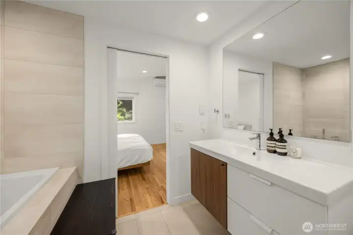 En suite bathroom with luxurious radiant underfloor heating for year-round comfort.