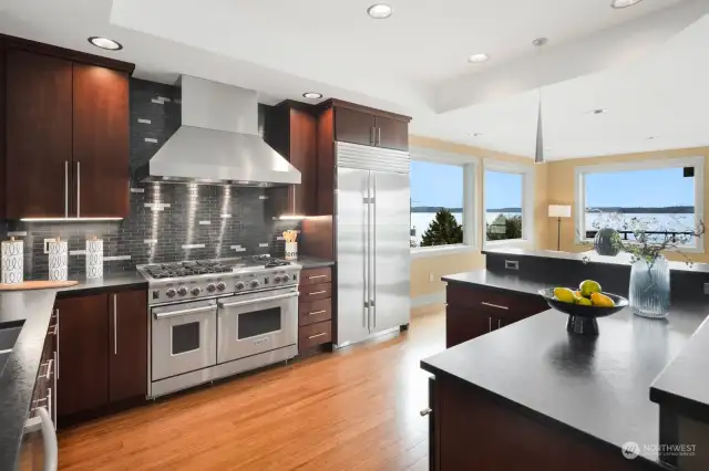 The well-appointed kitchen features top-of-the-line appliances including a 48” Wolf range, SubZero fridge and double ovens.