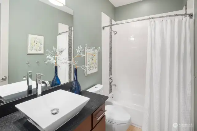 This second level full bathroom is perfectly placed in the hall, servicing two the bedrooms on this floor.