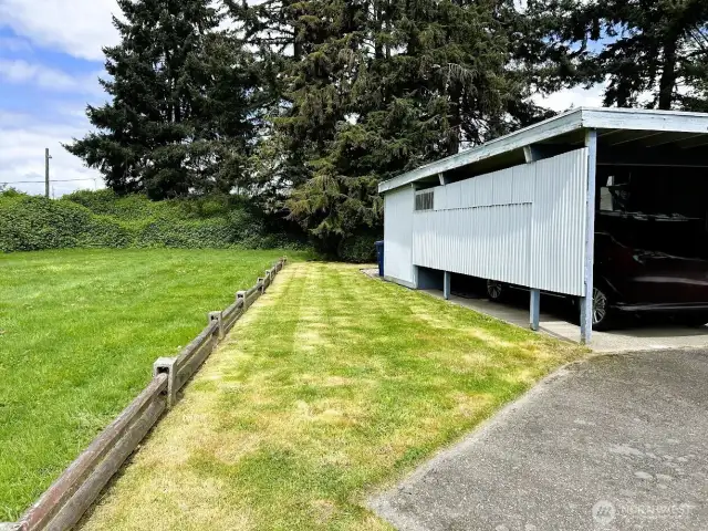 Grass area to the left of the home, maintained by HOA. This makes the home feel secluded and private.