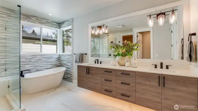 Sumptuous Primary 5-Piece Bath featuring heated tile floor, floating double-sink vanity, soaking tub & rain shower head. (Model Home photo)