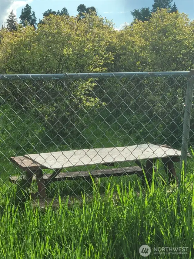 Chain link fencing along front/street side of farm.