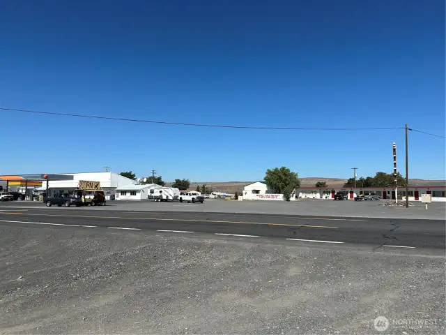 Across intersection from fuel station, motel, and storage units