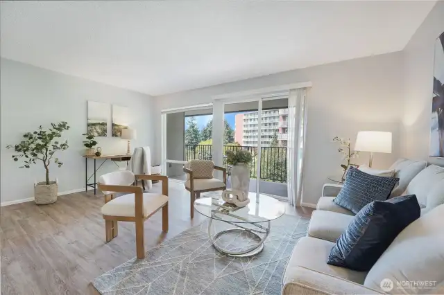 As you arrive at 402B, lovely new vinyl floors throughout.  This is the living room large enough for a desk.  Great deck off the living room of this top floor condo