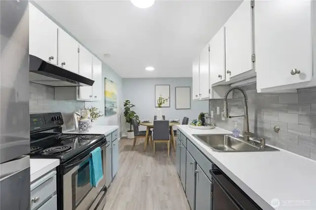 This is the kitchen as you enter the condo on the left.  Newer appliances and lots of storage in this hard working kitchen.  New fixtures throughout the condo and that lovely vinyl flooring.  All new hardware in the kitchen and new backsplash as well