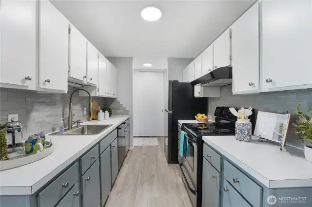 Looking from the dining area into the kitchen.  There is a large closet by the entry (shown straight ahead)