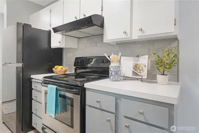 Closeup of the stove, fan and refrigerator