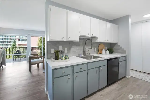 Kitchen with dishwasher and sink/faucet.  Lots of countertop space and a clean, modern look