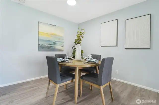 The dining area, here shown with round table and 4 chairs but the space can easily accommodate a rectangular table for six.  The condo was freshly painted throughout
