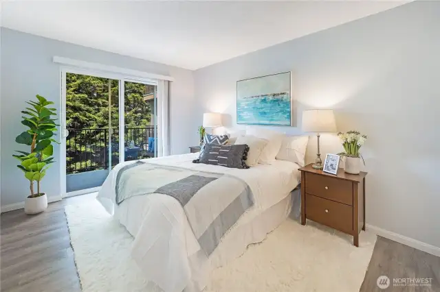 This is the Primary bedroom with its own deck (some would say better views of the water from here) and an ensuite 3/4 bathroom.  This bedroom shown with a Queen sized bed